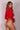 Back photo of a model wearing a red long-sleeve swimsuit from Lonarc