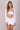 Front photo of a model wearing a white body long sleeve + skirt Lonarc